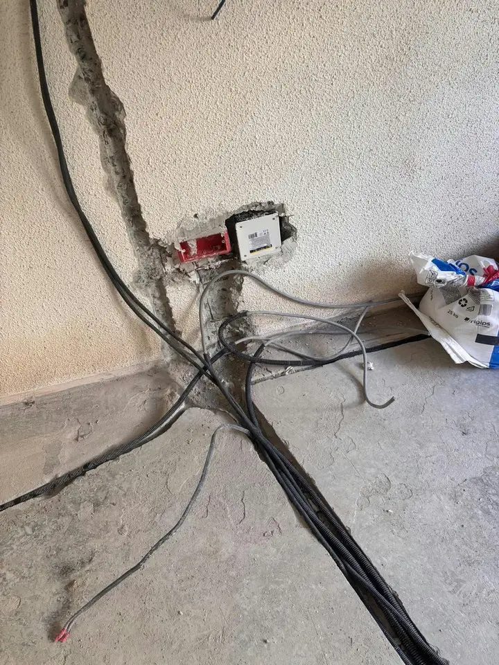 Doză și priză montate la baza peretelui, cu cabluri care coboară spre pardoseală